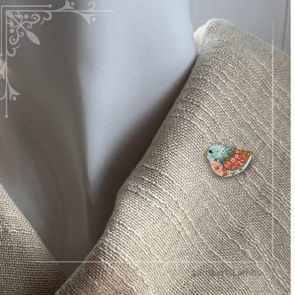 Hand painted bird brooch in blue pink and gold