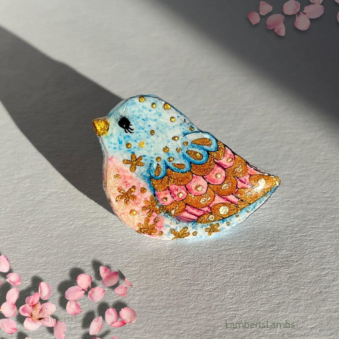 Hand painted bird brooch in blue pink and gold