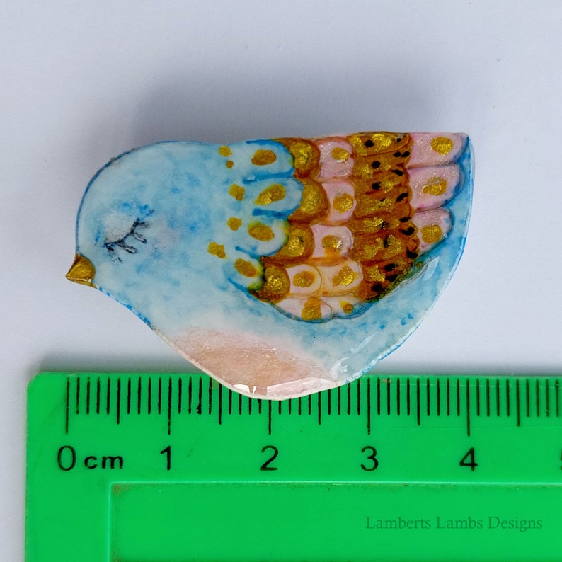 Artsy hand painted light blue, pink and gold bird brooch
