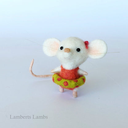 White needle felted mouse in an orange swimsuit with an inflatable ring.