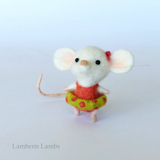 White needle felted mouse in an orange swimsuit with an inflatable ring.
