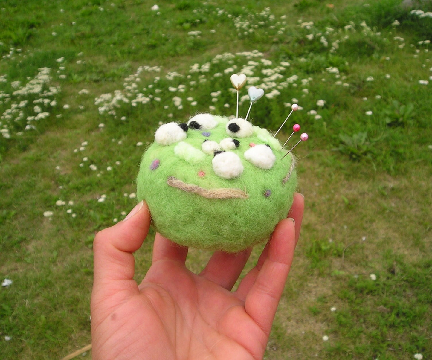 Needle felted pin cushion of sheep in the meadow